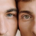 Intimate close-up of two young men showcasing a loving bond and diversity.